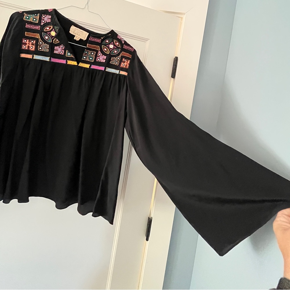 Flowy black top with embroidered and appliqué details. Party Dressy Celebration.